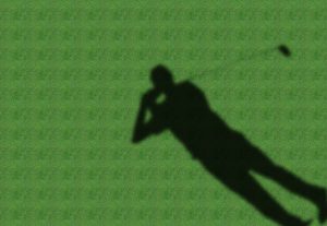 a shadow of golfer in a green fairway