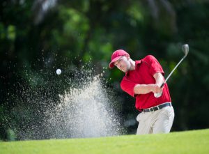 Golfer playing shot.