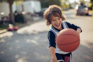 Close up of a young boy playing basketball